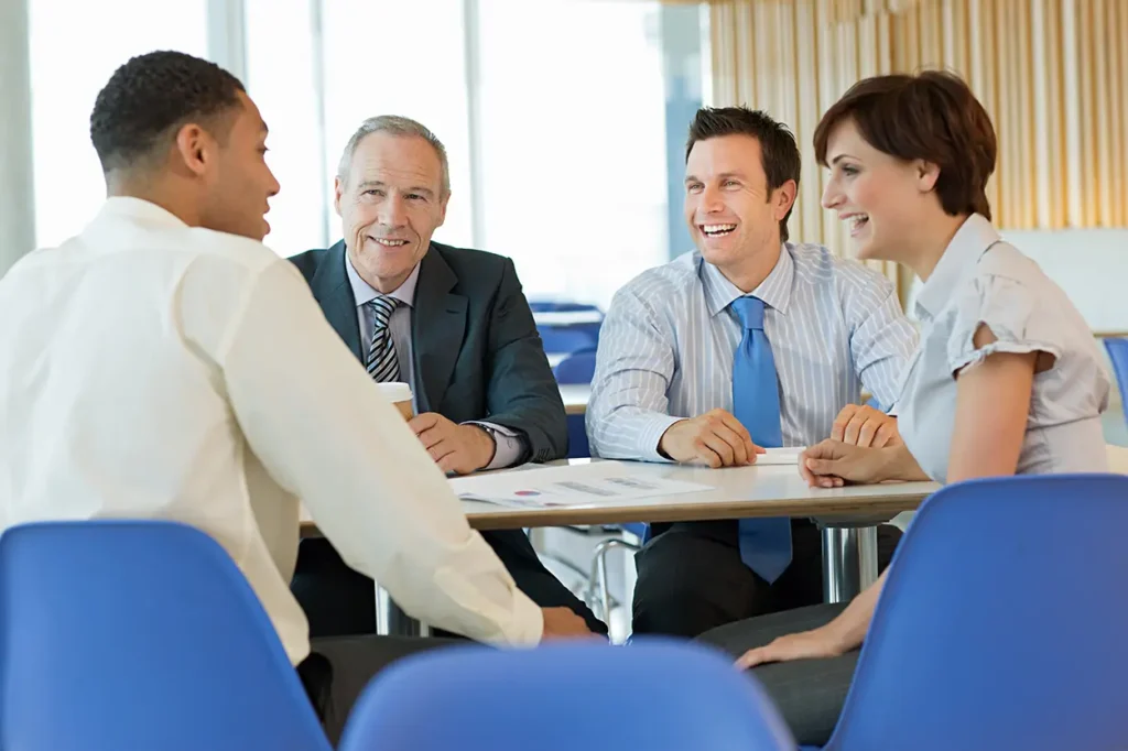 smiling businesspeople in meeting
